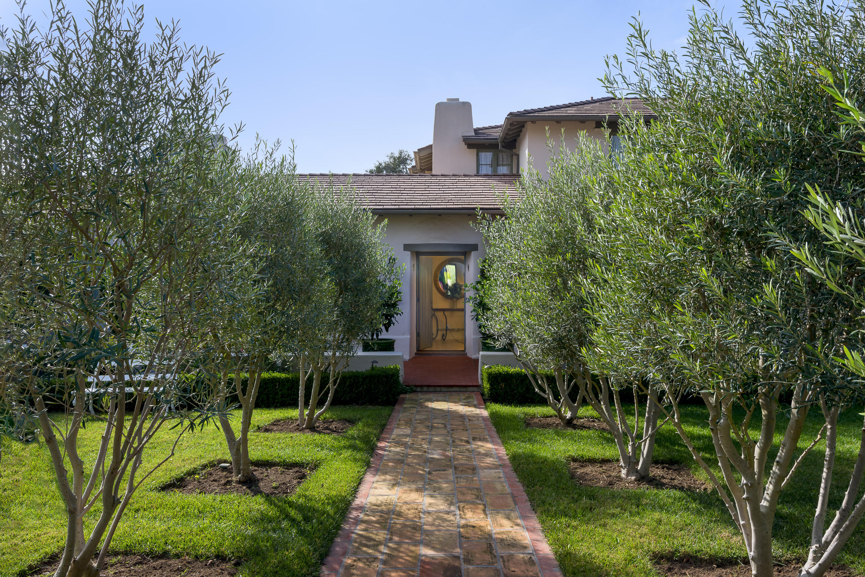 a front view of a house with garden