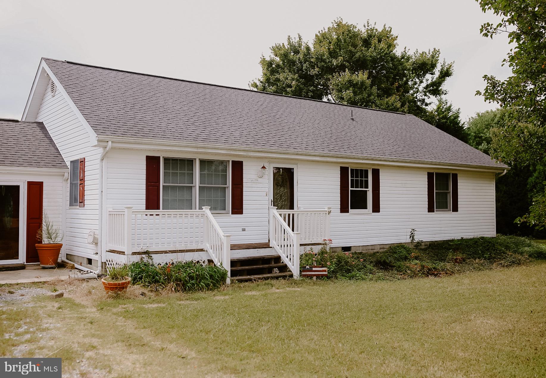 a front view of a house with a garden and yard