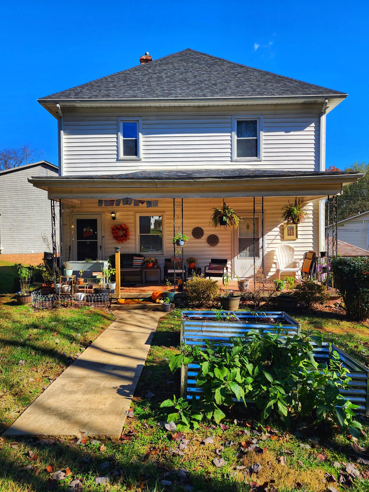 a front view of a house with swimming pool having outdoor seating