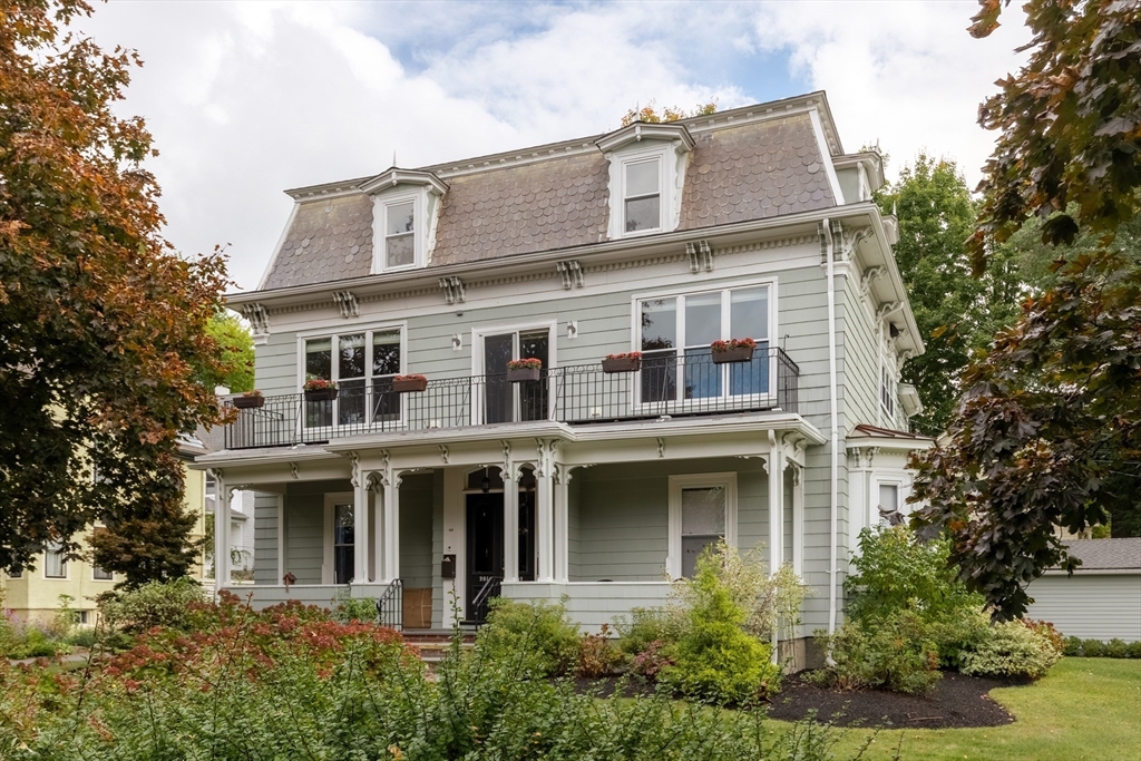 a front view of a house with a garden