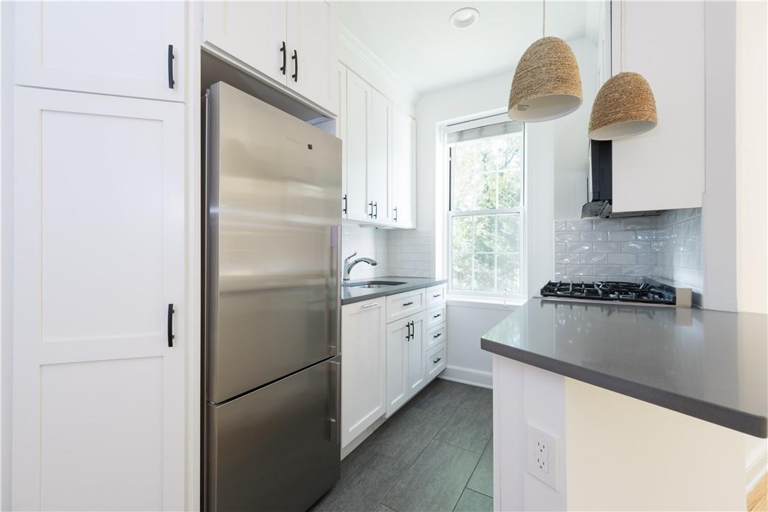 a kitchen with a refrigerator and a sink