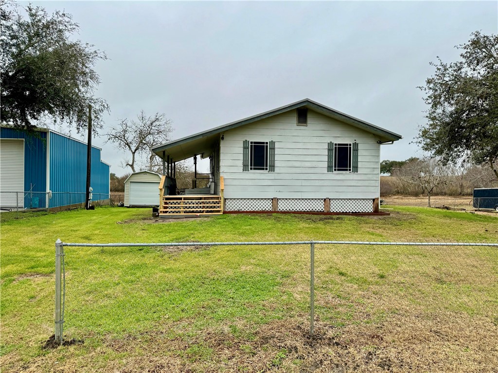 a front view of house with yard and swimming pool