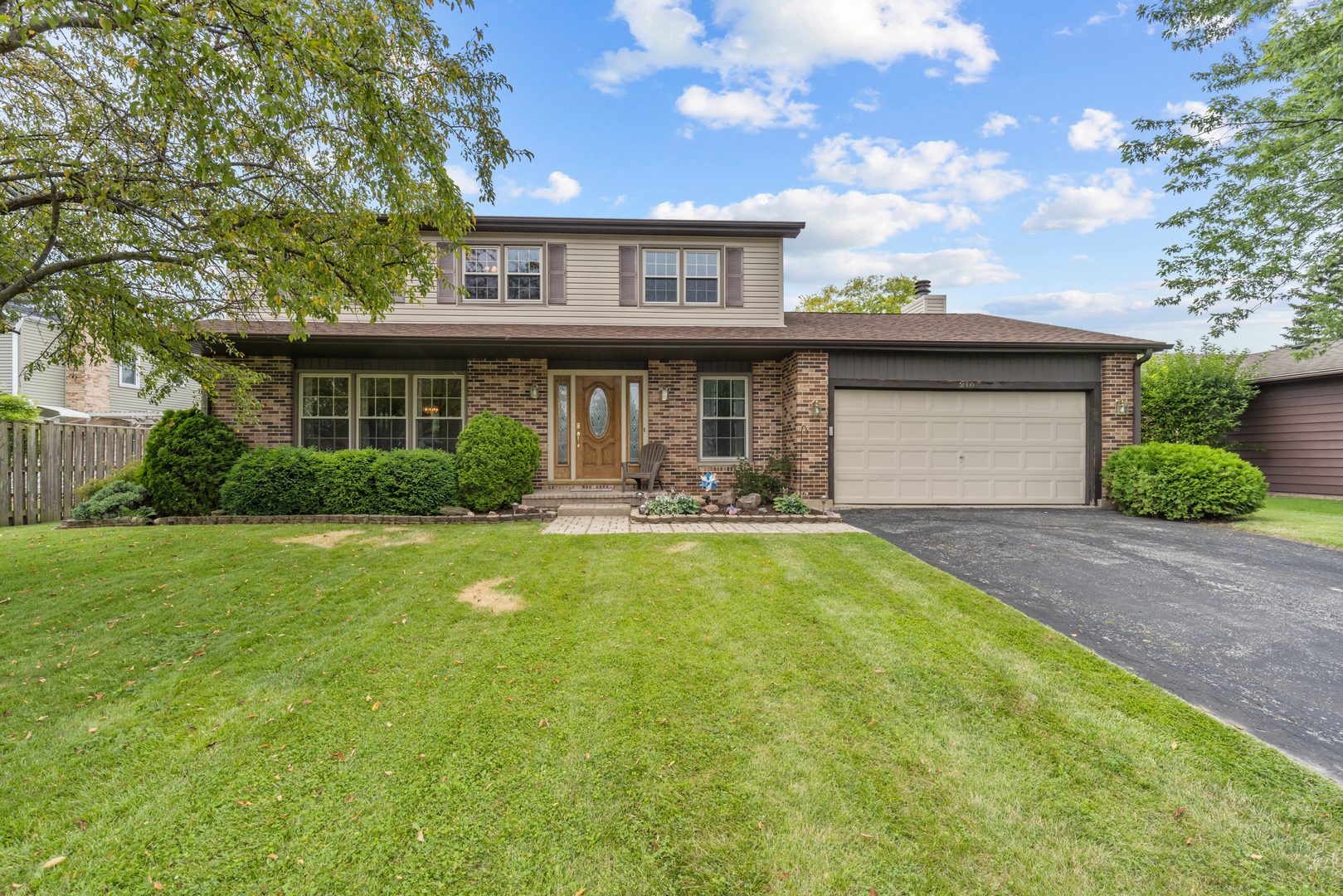 a front view of house with yard and outdoor seating