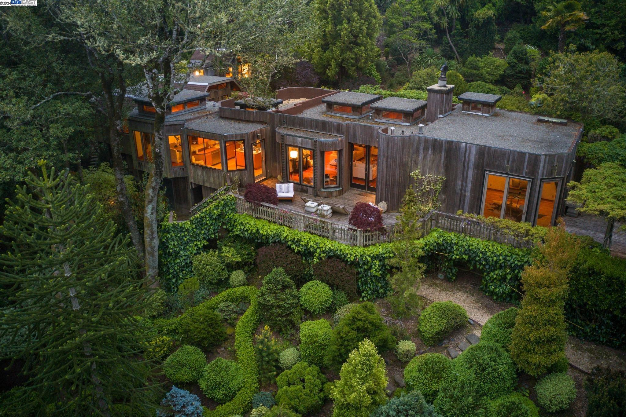 an aerial view of a house with garden space and street view