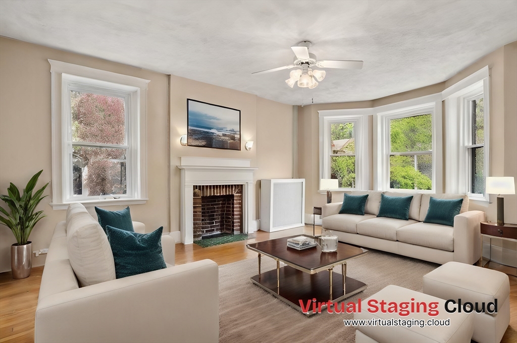 a living room with furniture large window and a fireplace