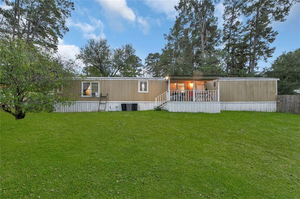 a view of a house with a backyard