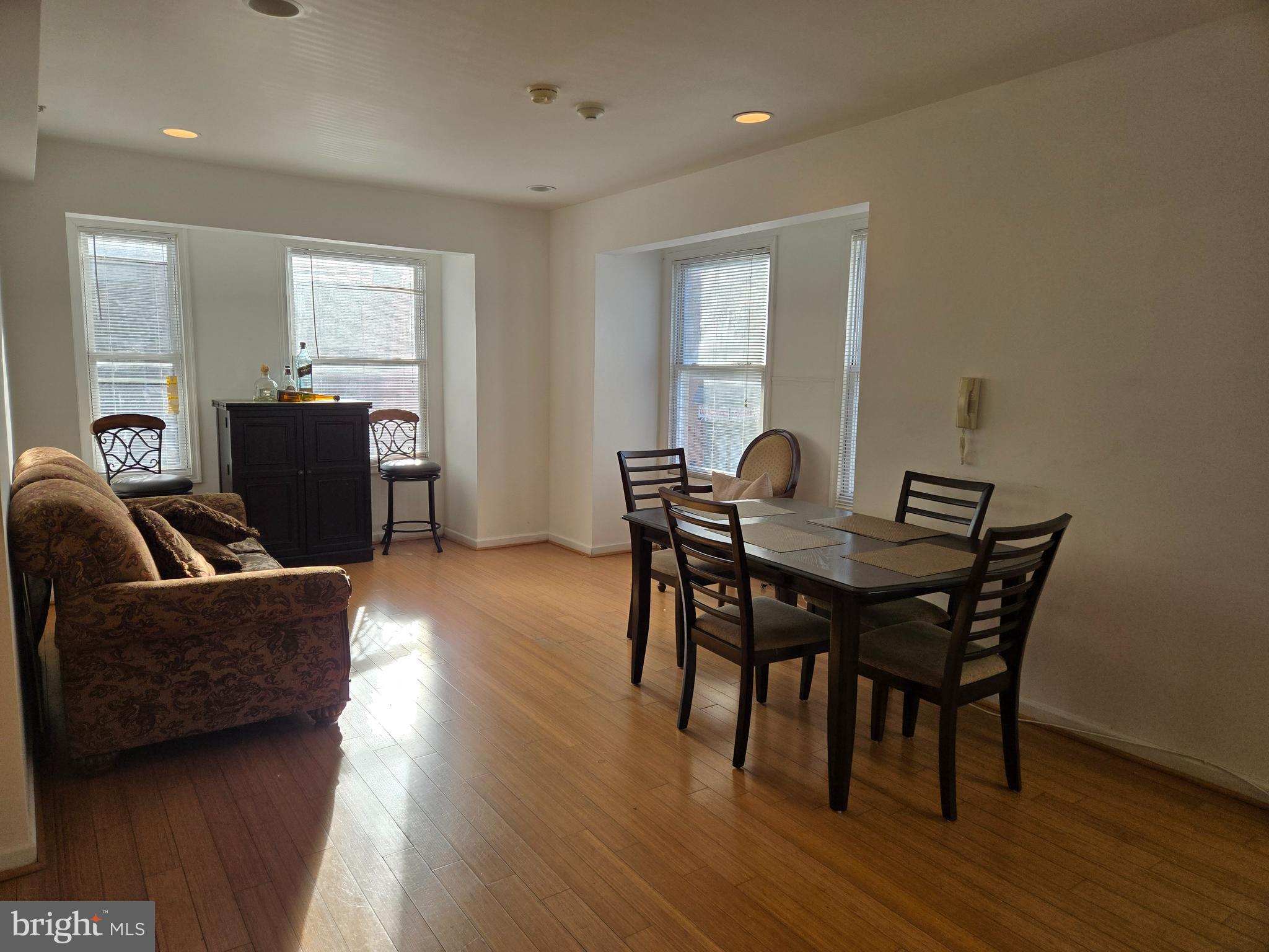 a view of a dining room with furniture and wooden floor