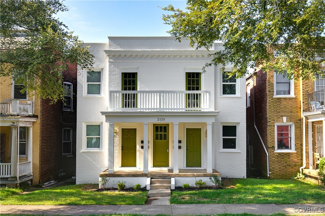 View of front of home featuring a balcony, a porch