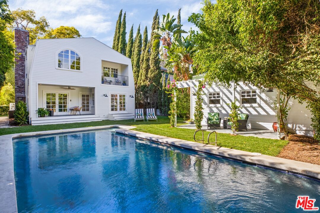 a view of a swimming pool with a yard