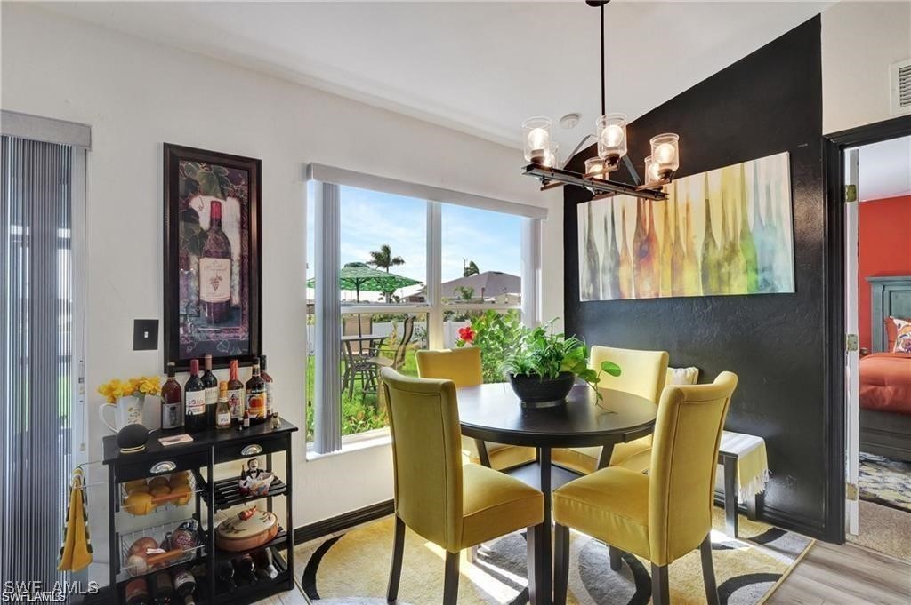 a view of a dining room with furniture and a chandelier