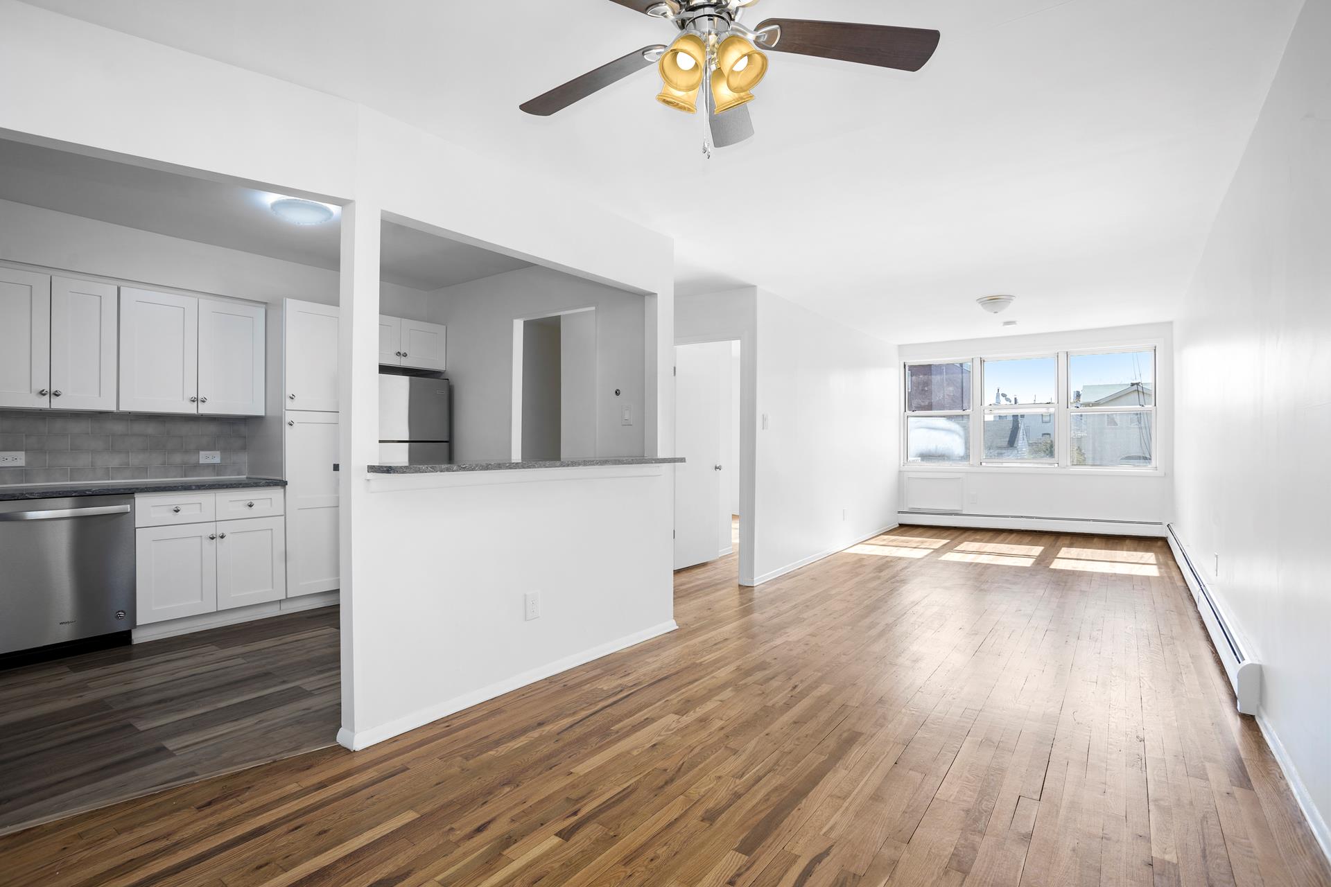 a view of a kitchen counter space and wooden floor