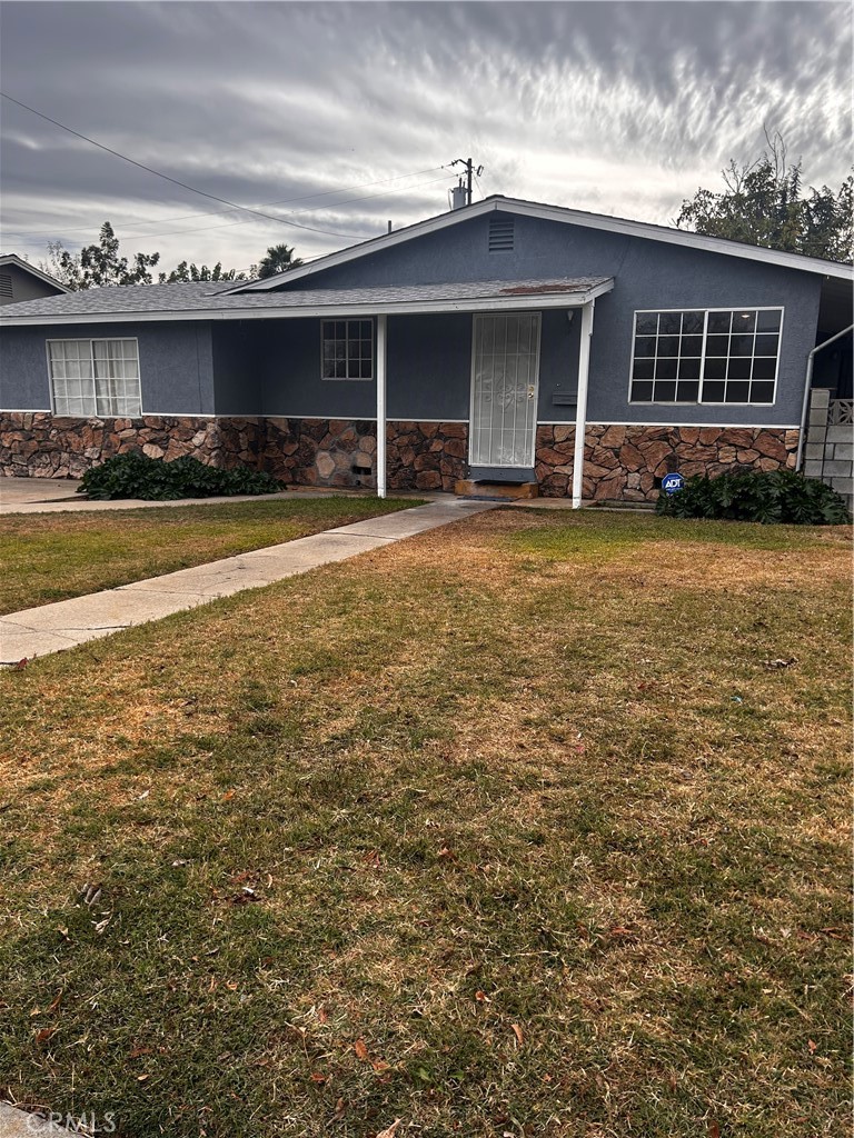 a front view of a house with a garden