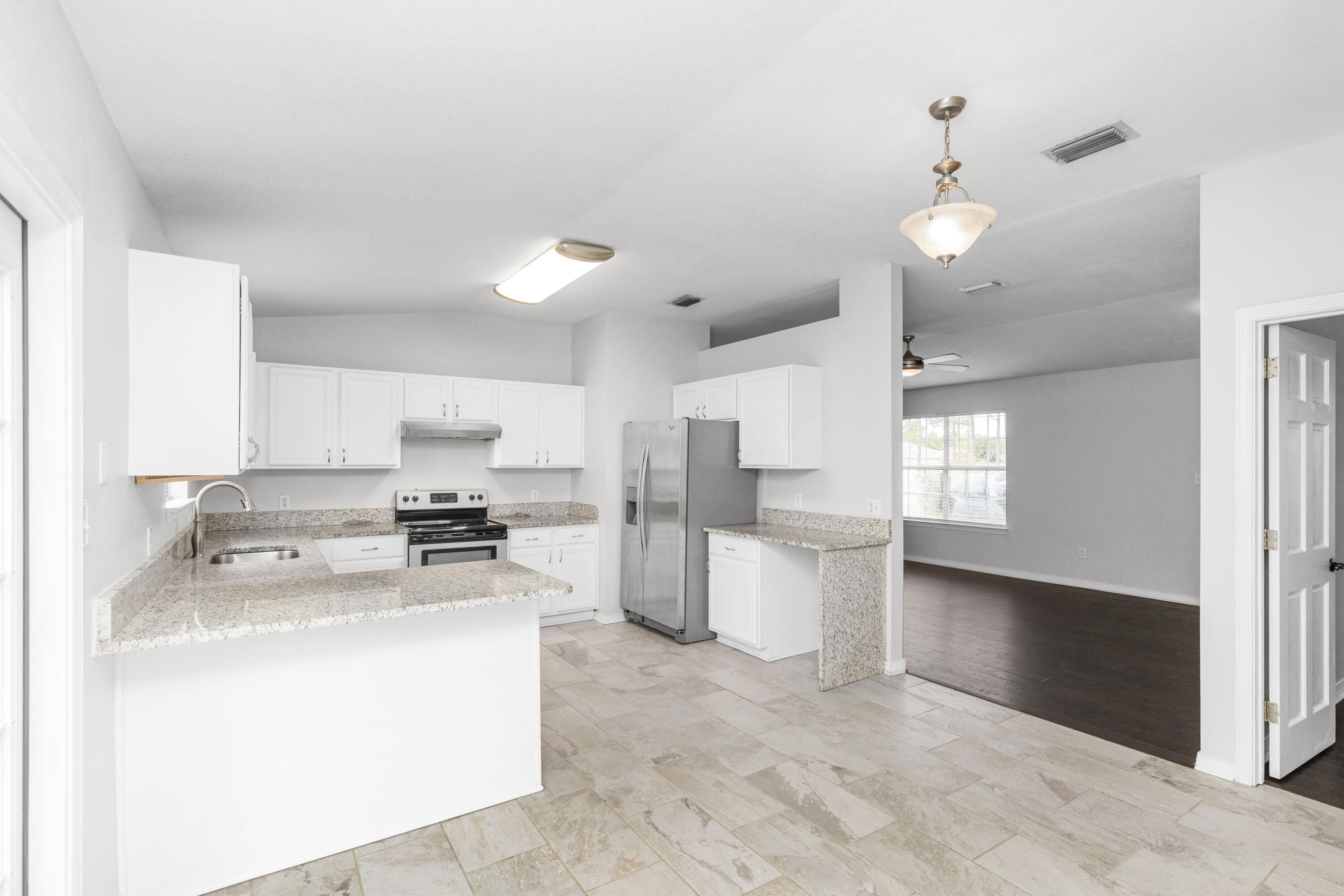 a kitchen with a stove a sink and a refrigerator