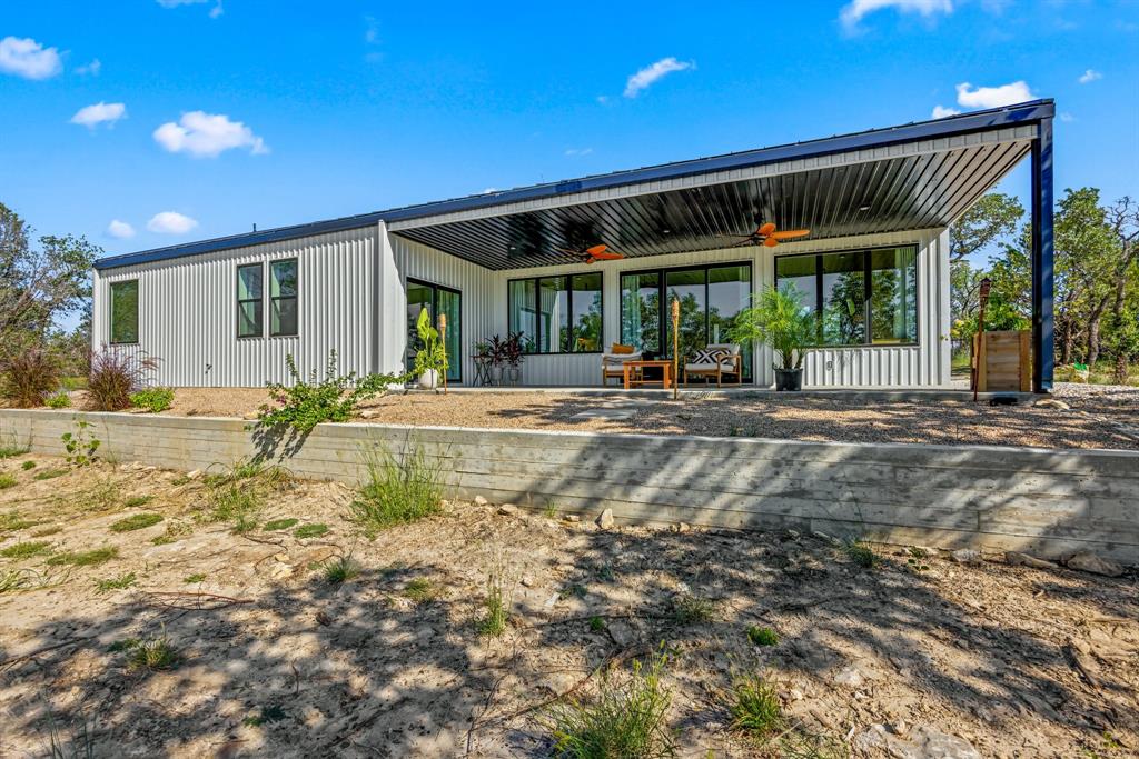 a front view of house with yard outdoor seating and barbeque oven