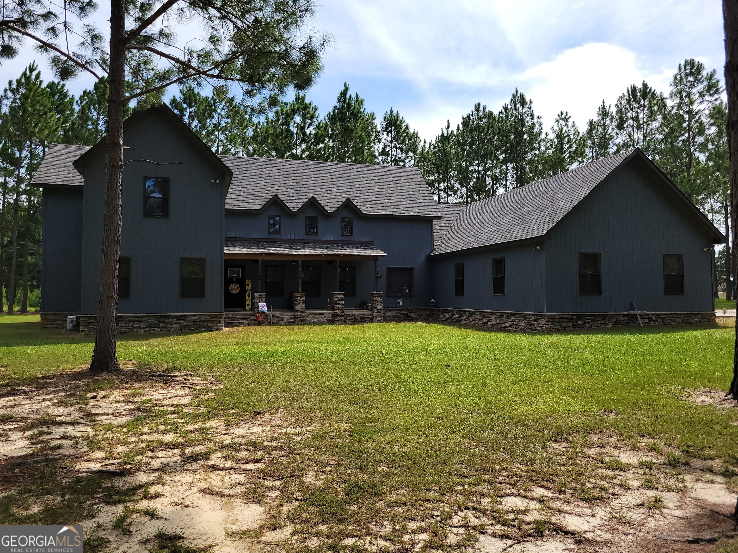 a front view of a house with a garden