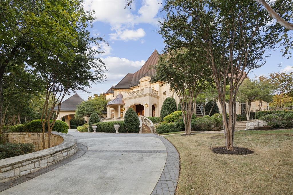 a front view of a house with a yard and tree s