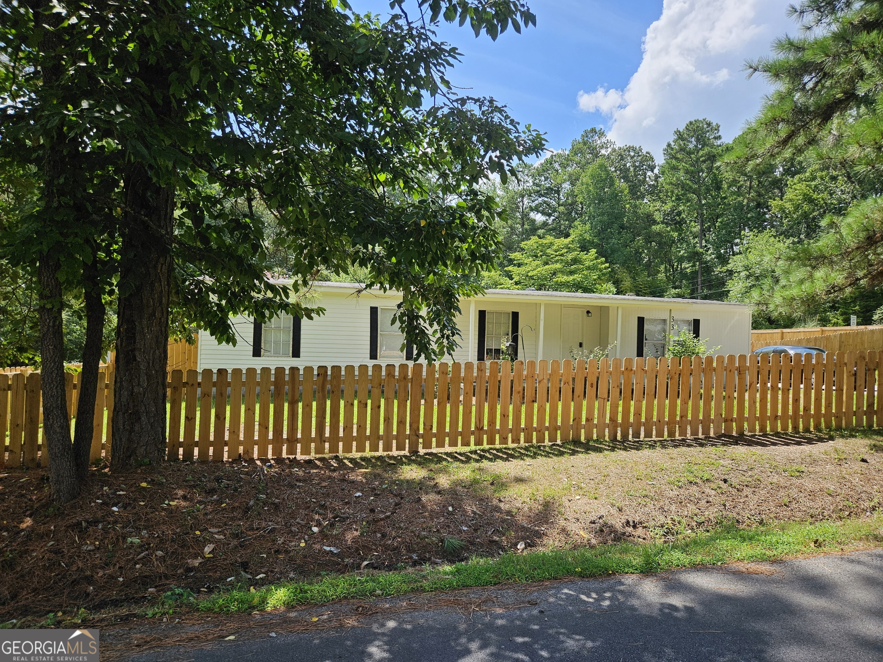 a view of a house with a fence