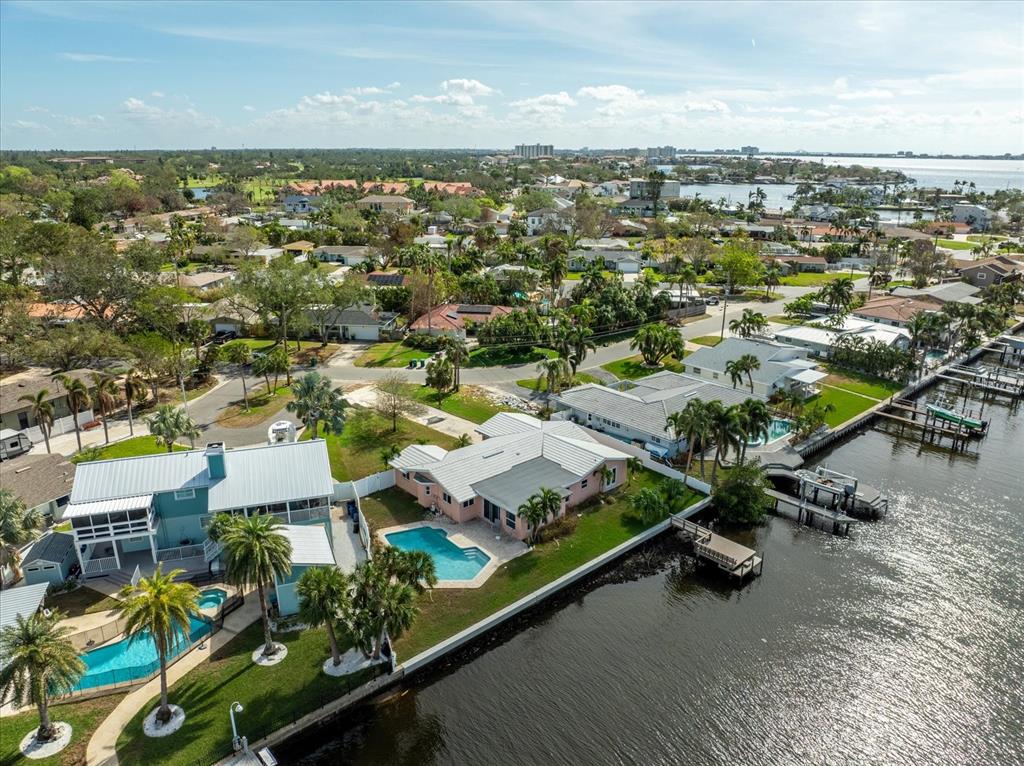 an aerial view of residential houses with outdoor space and parking