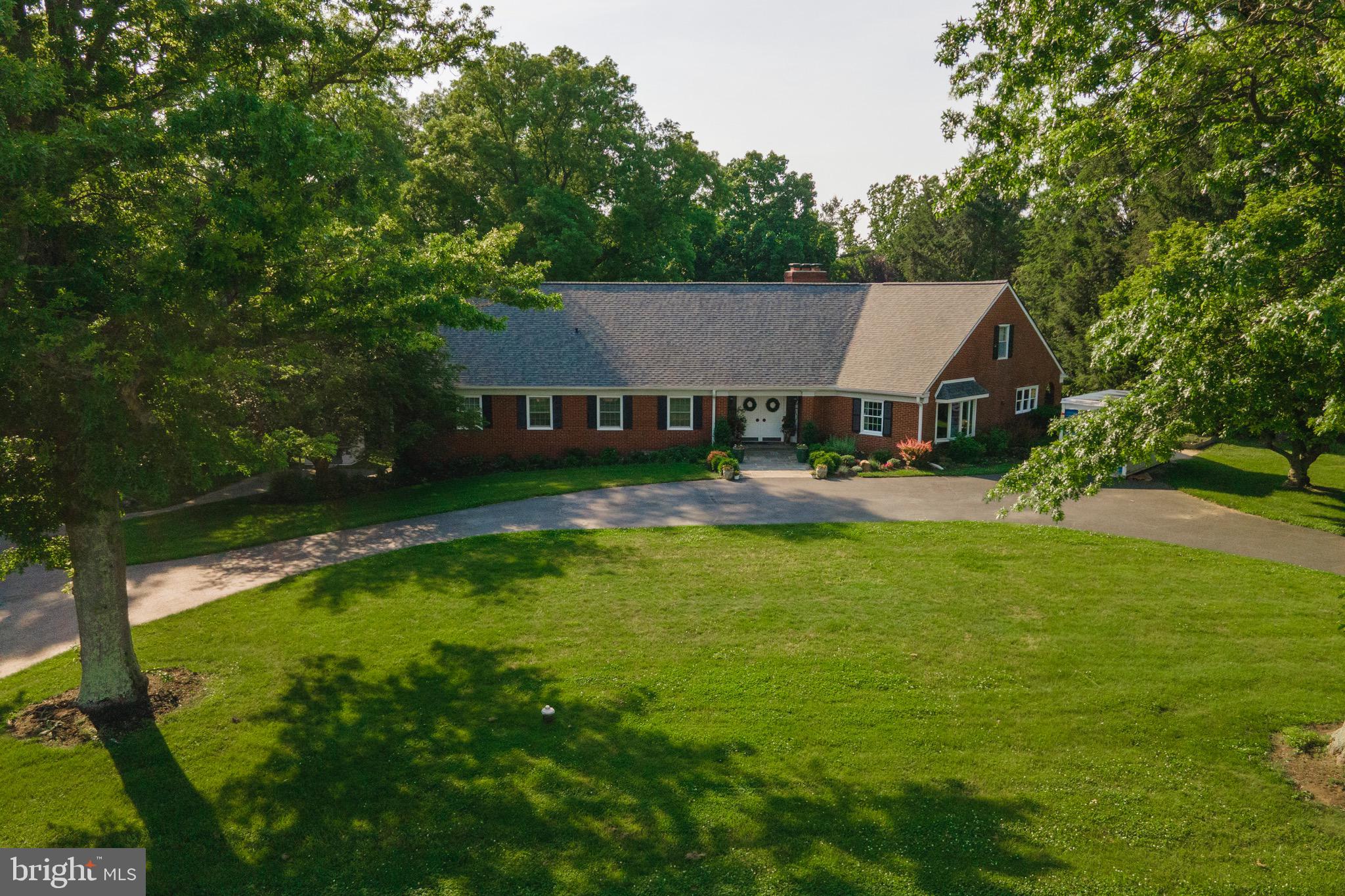 a aerial view of a house with swimming pool and green yard