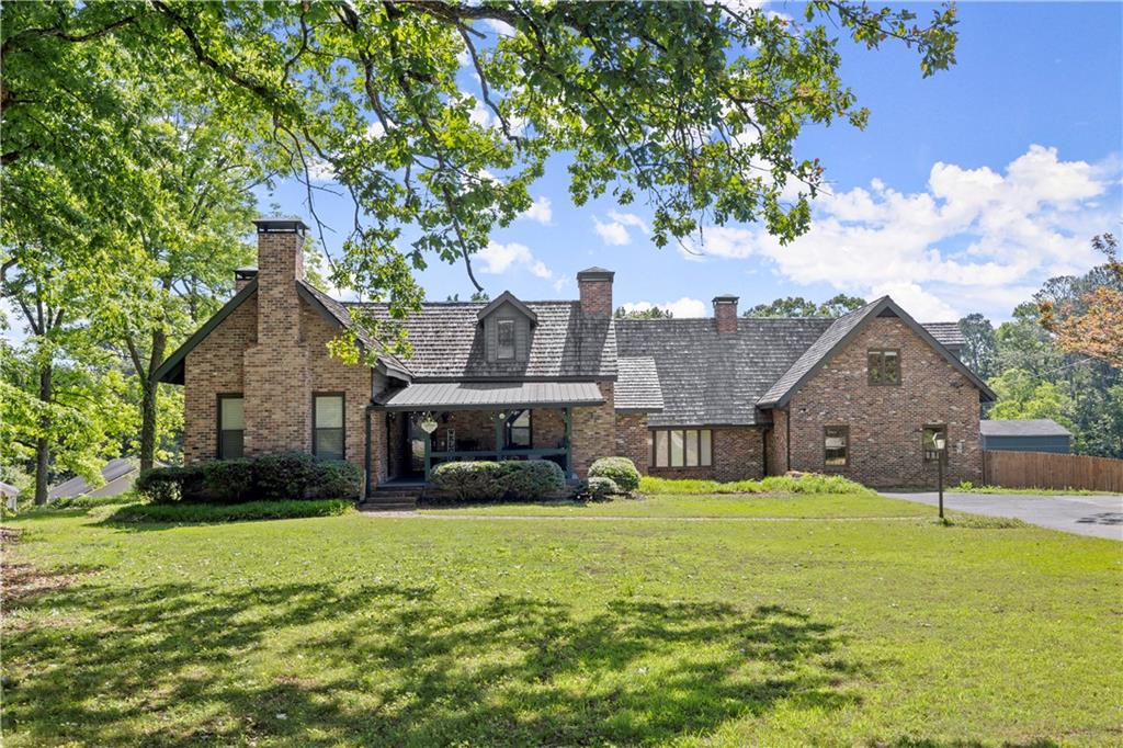 a front view of house with yard and green space