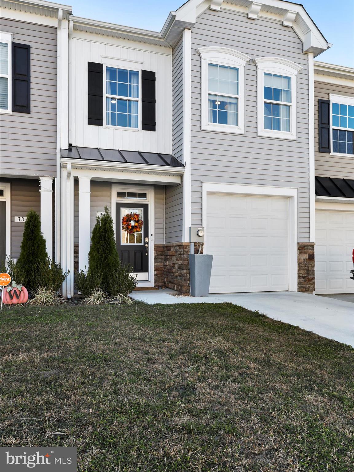 a view of a house with a yard and garage