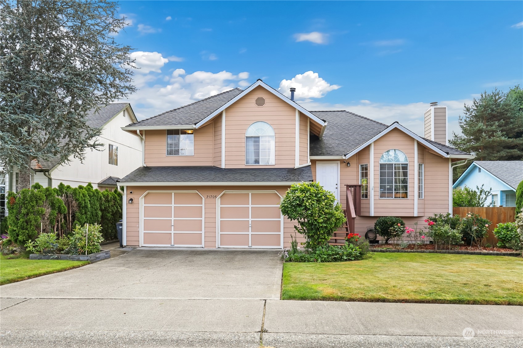 a front view of a house with a yard and garage