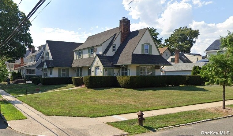 a view of house with yard and entertaining space