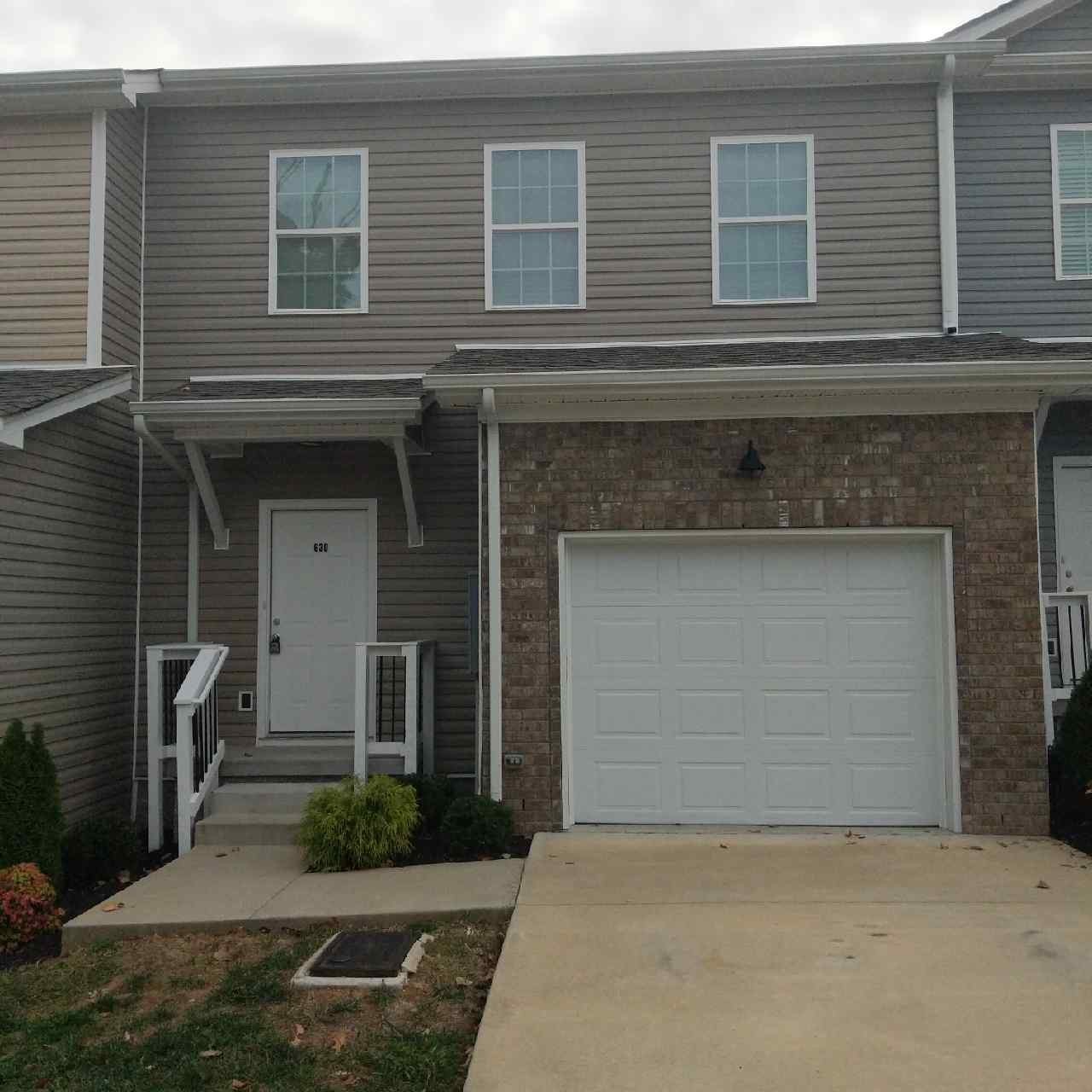 a front view of a house with yard