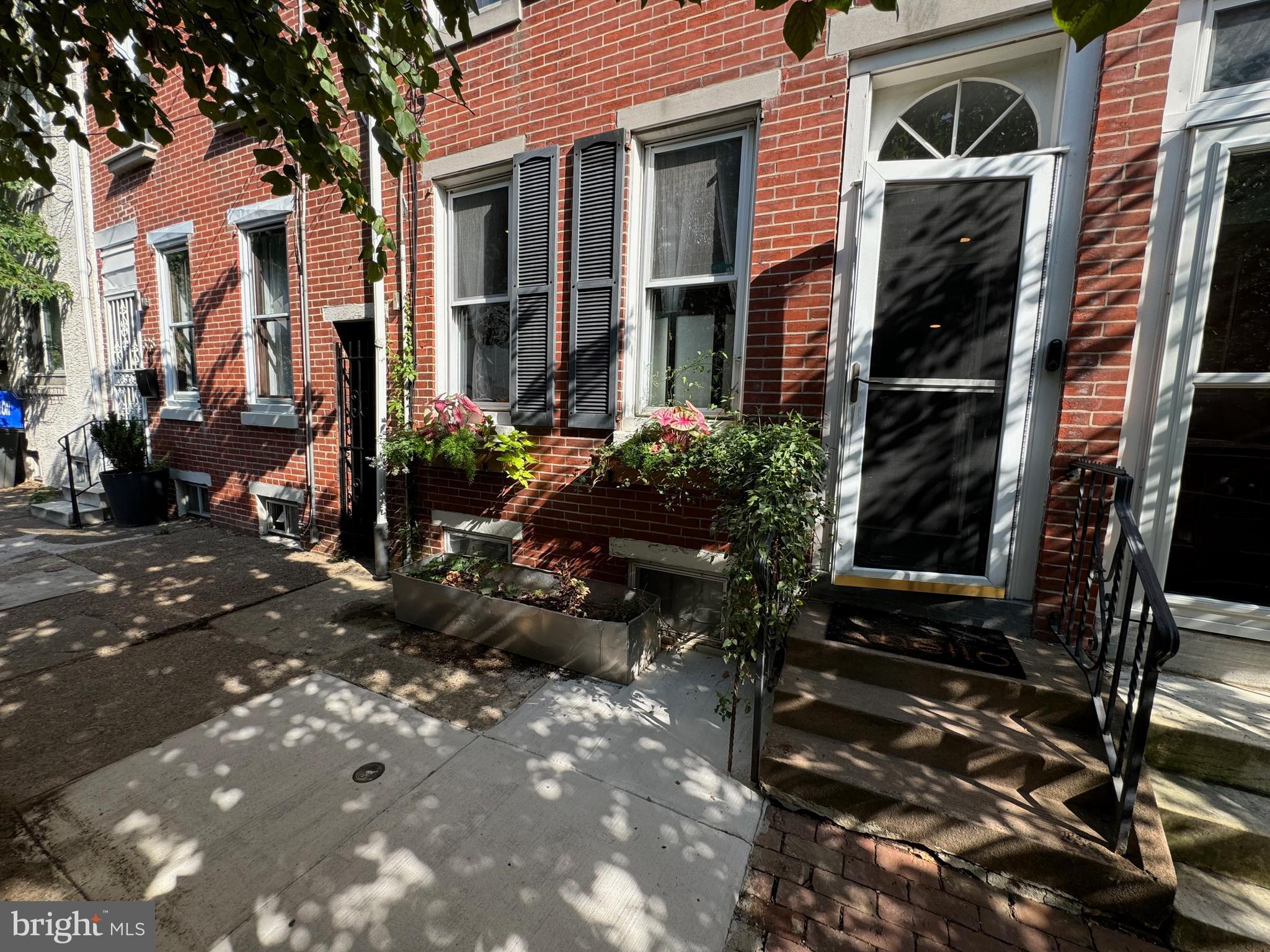 a view of a house with a yard and sitting area