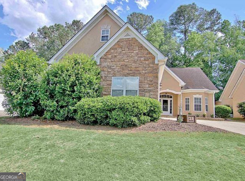 a front view of a house with a yard