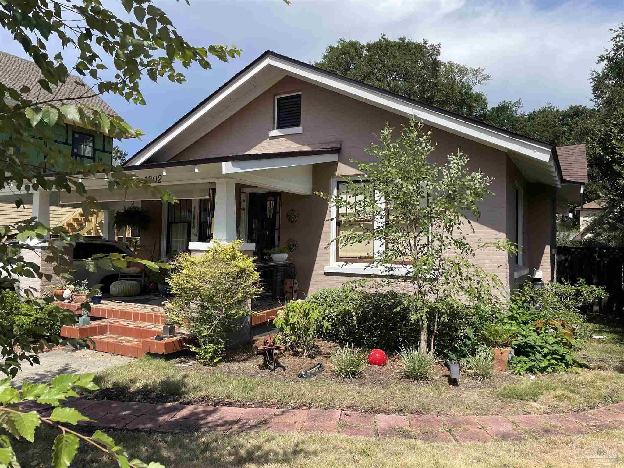 a view of a house with potted plants