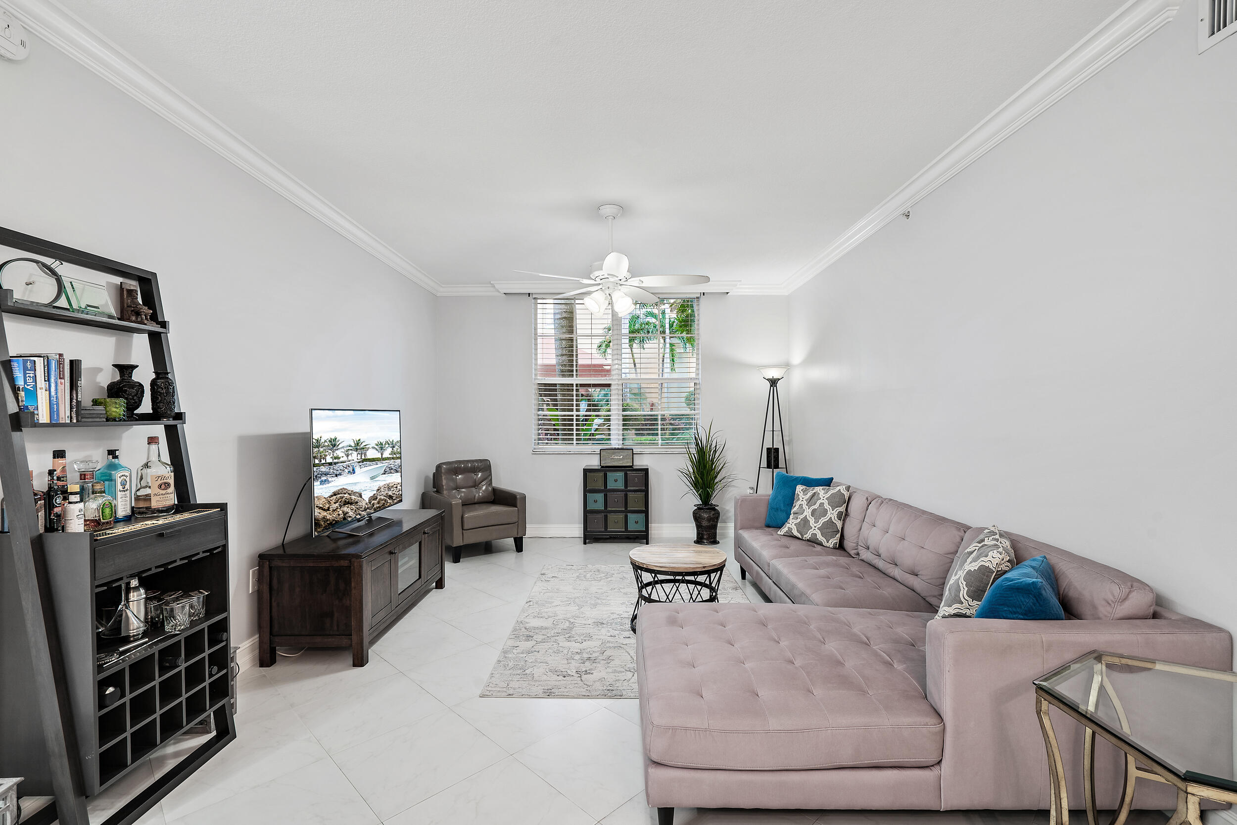 a living room with furniture a fireplace and a window