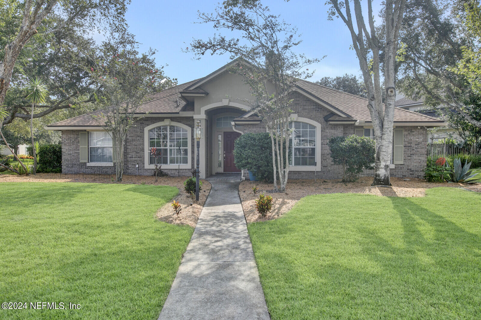 a front view of a house with a garden and porch