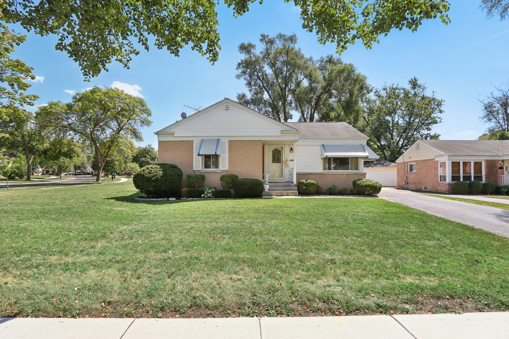 a front view of a house with a garden