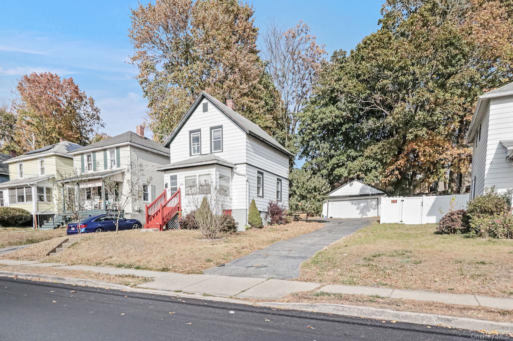 a view of white house with a yard