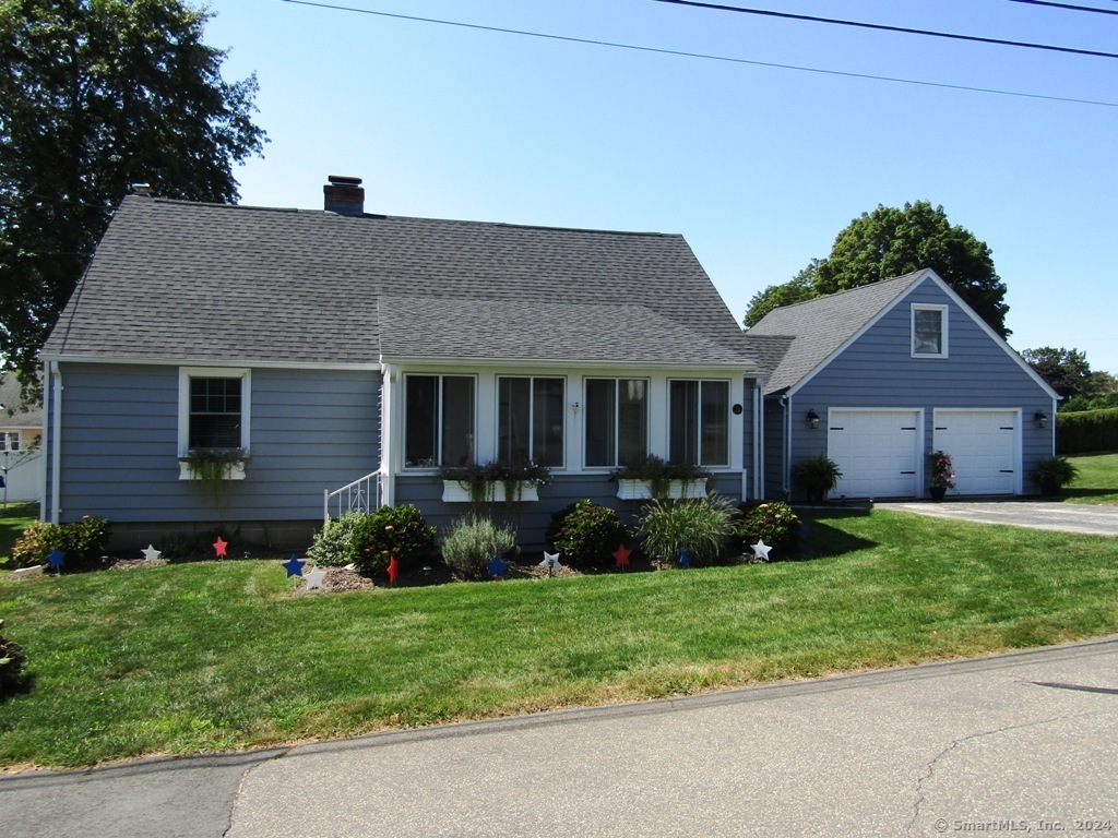 a front view of a house with a garden