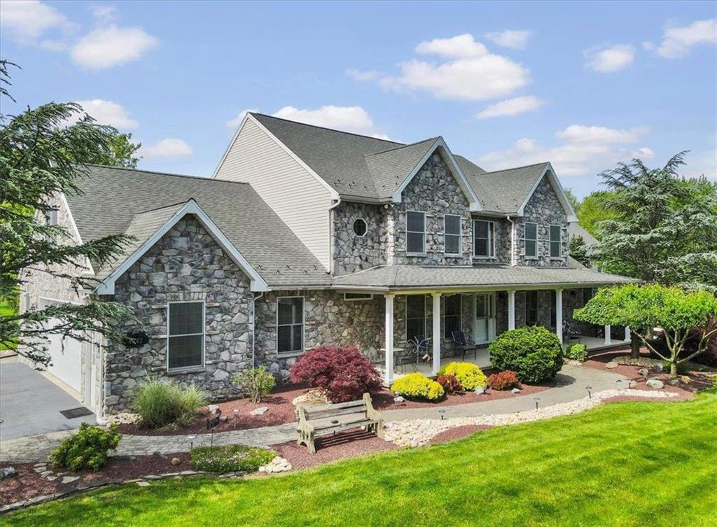 a front view of a house with garden and porch