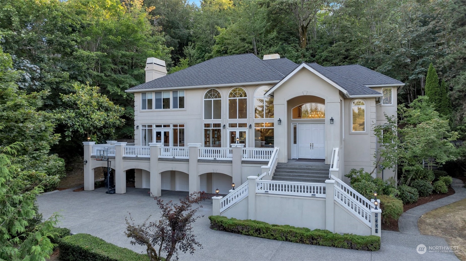 a front view of a house with yard and parking