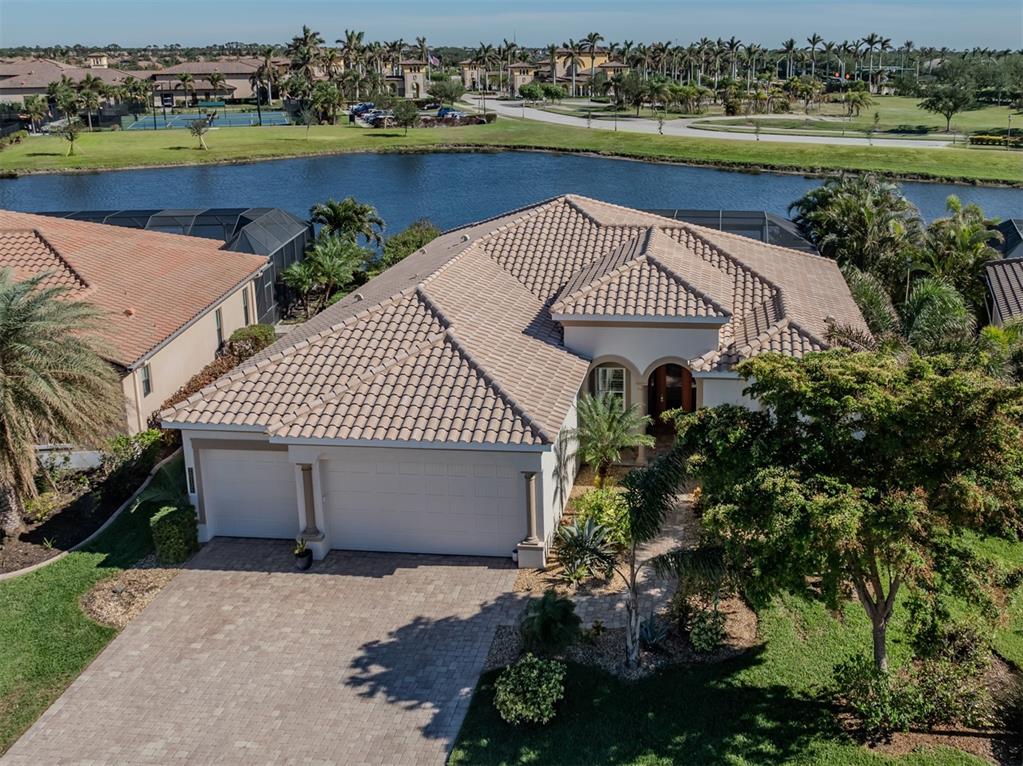 an aerial view of a house with a garden and lake view