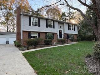 a front view of a house with yard and green space