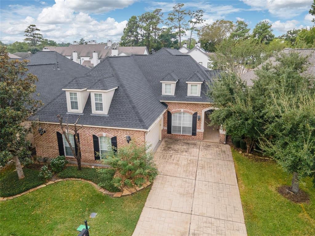 Charming 1.5-story brick home nestled on a quiet cul-de-sac, featuring manicured landscaping and mature trees for a serene suburban retreat.