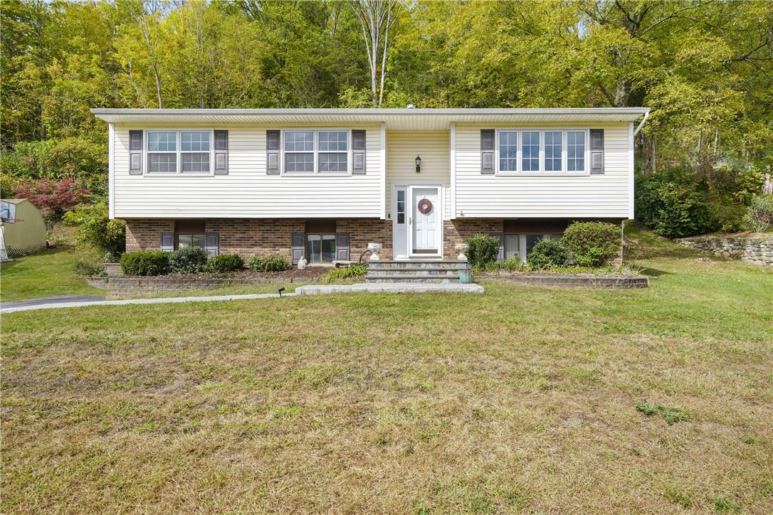 Raised ranch featuring a front lawn