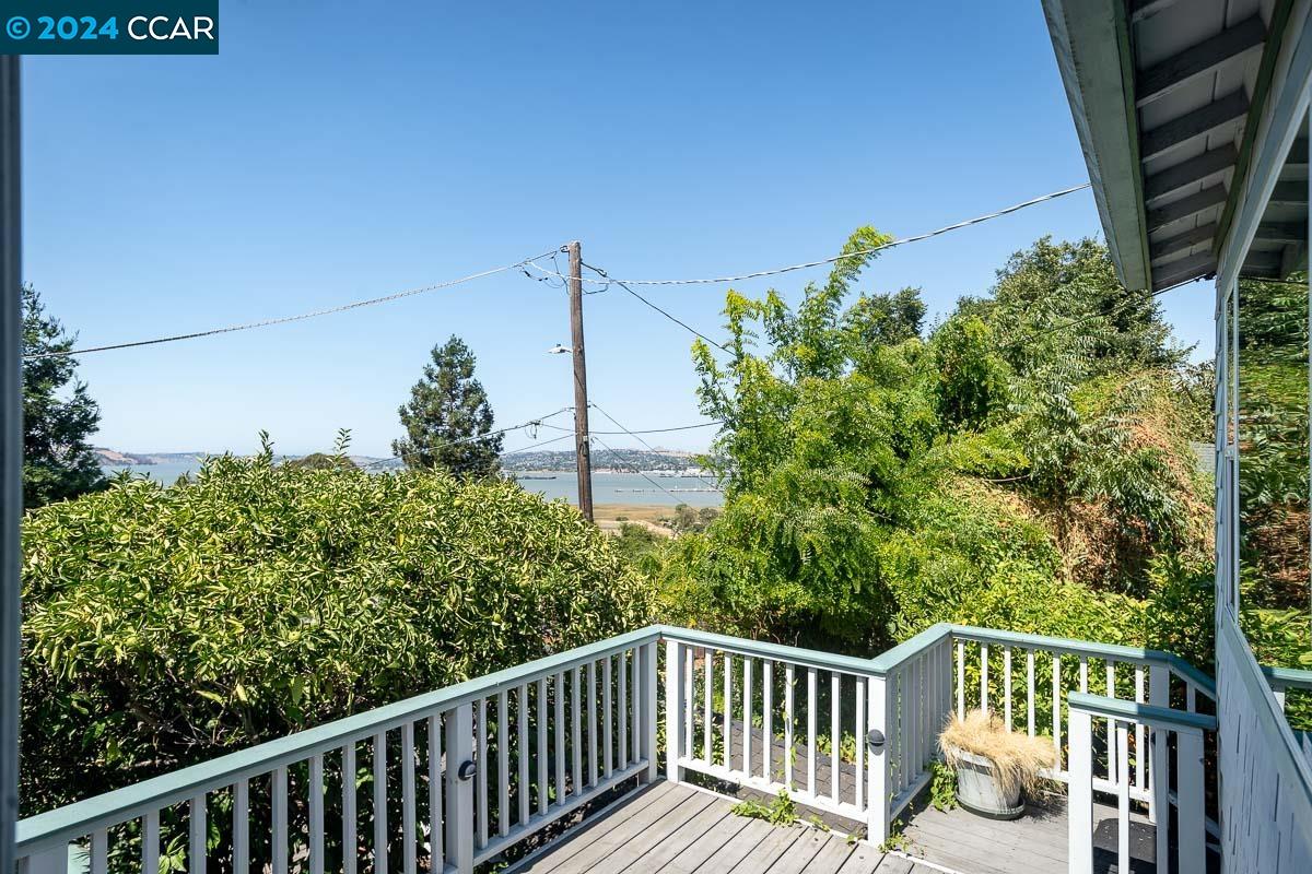 a view of a balcony with wooden fence