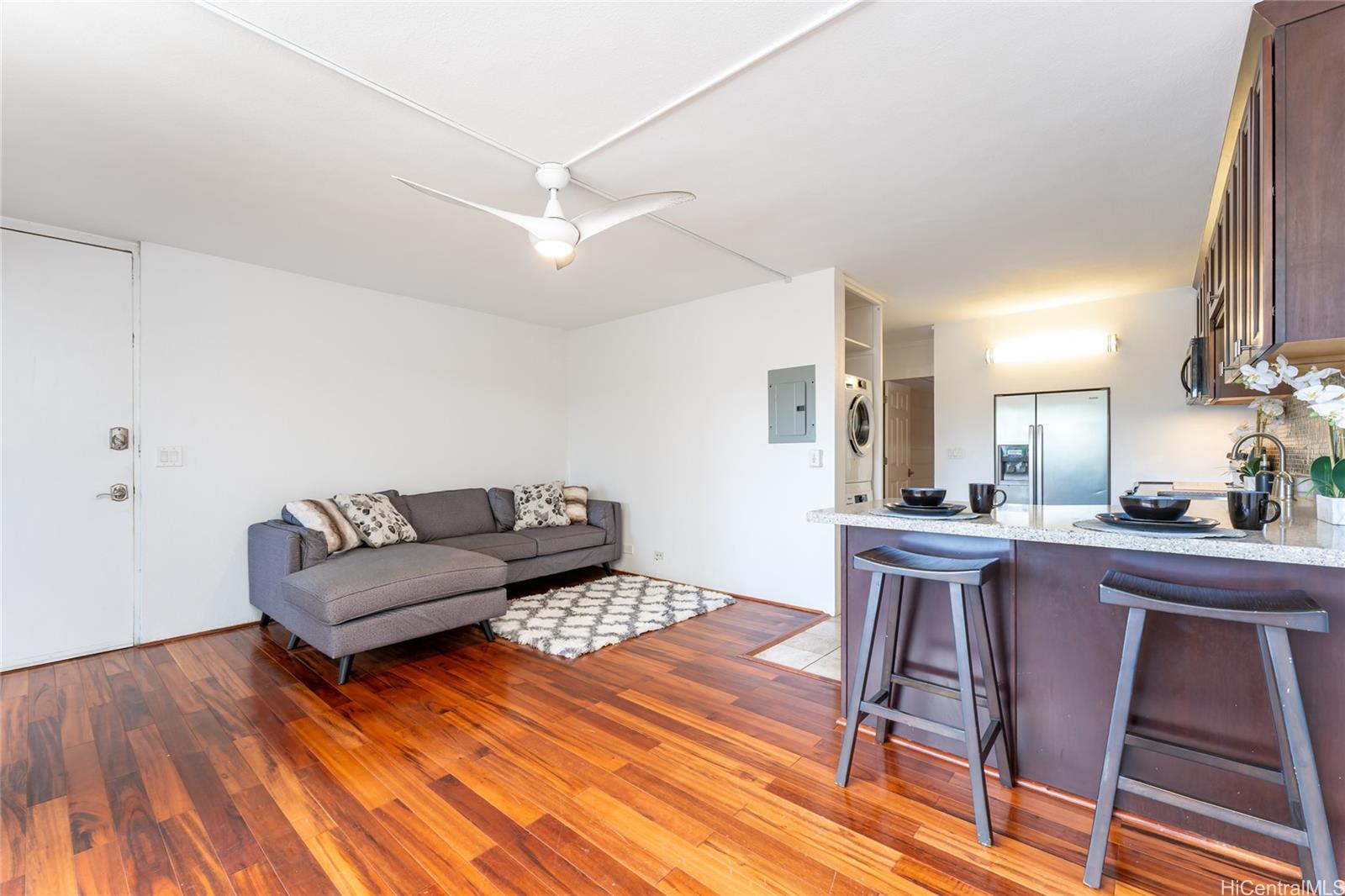 a living room with furniture and a wooden floor