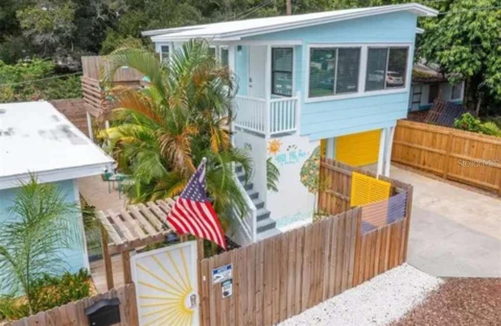 a view of a house with backyard and sitting area