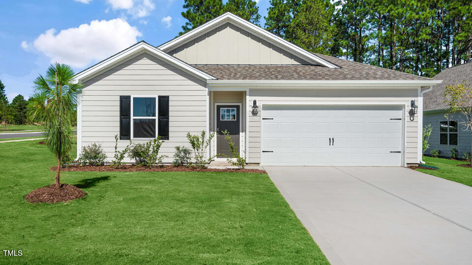 a front view of house with a garden