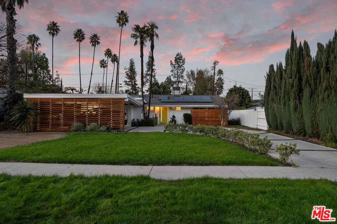 a view of outdoor space with garden and trees