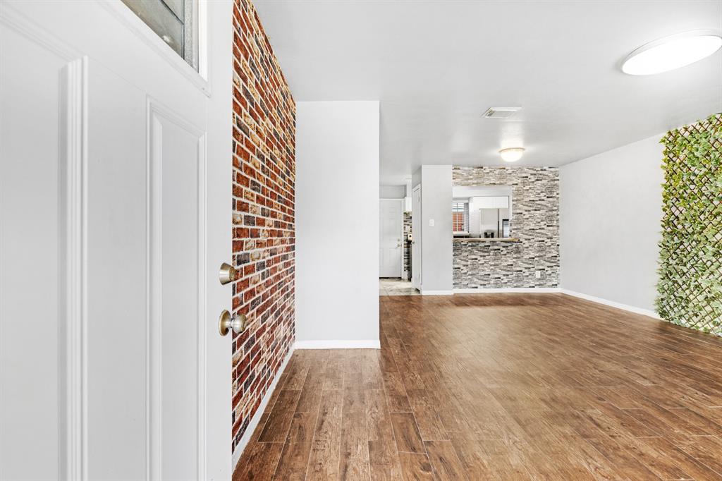 a view of hallway with wooden floor