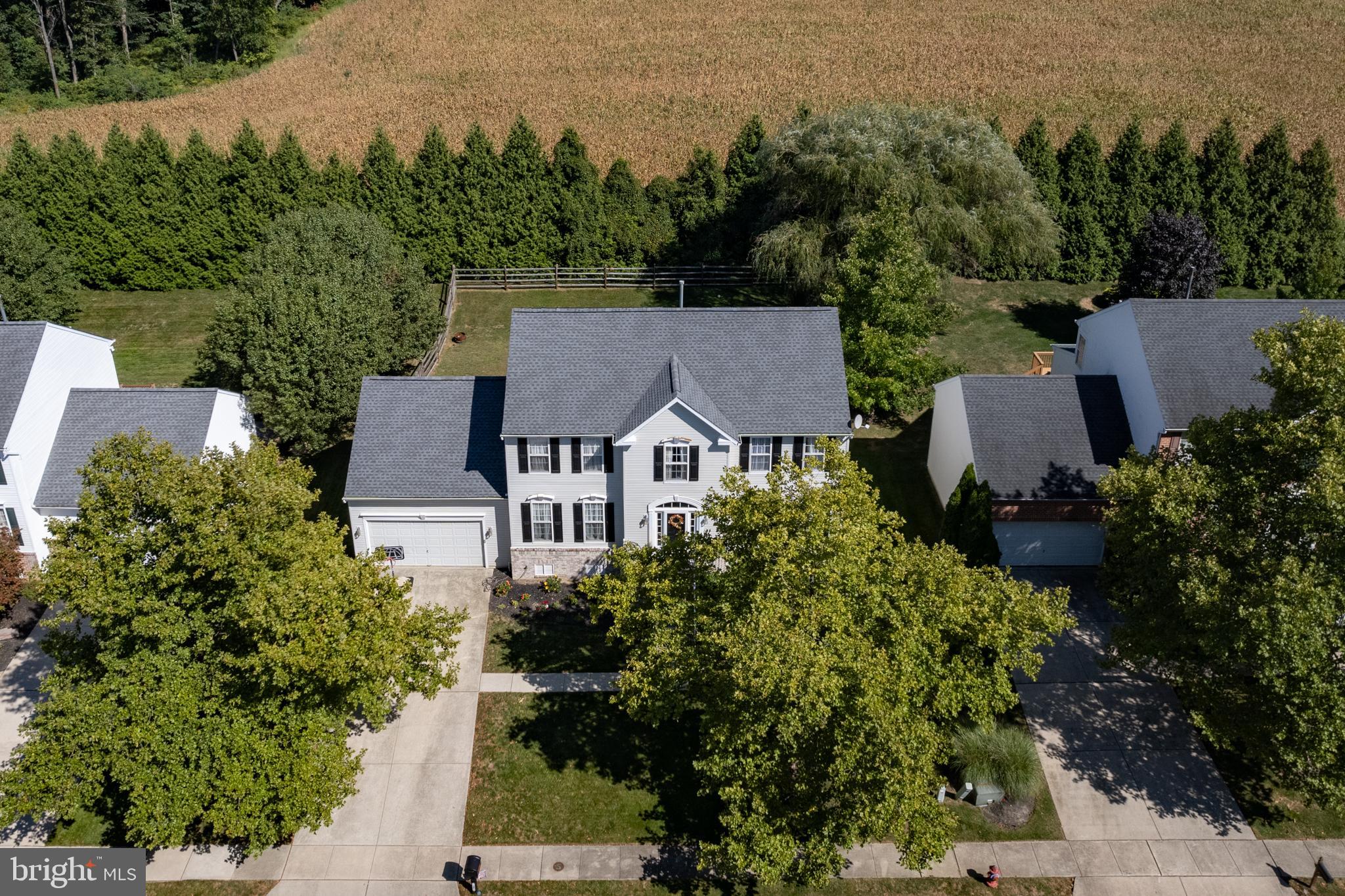 an aerial view of a house with a garden and trees