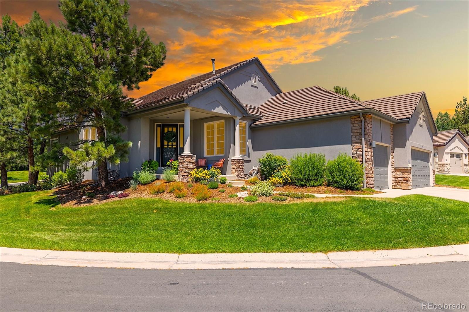 a front view of house with yard and green space